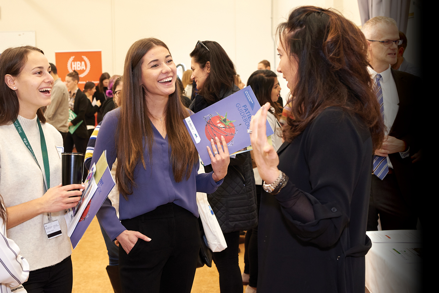 a group of female student chatting at an event